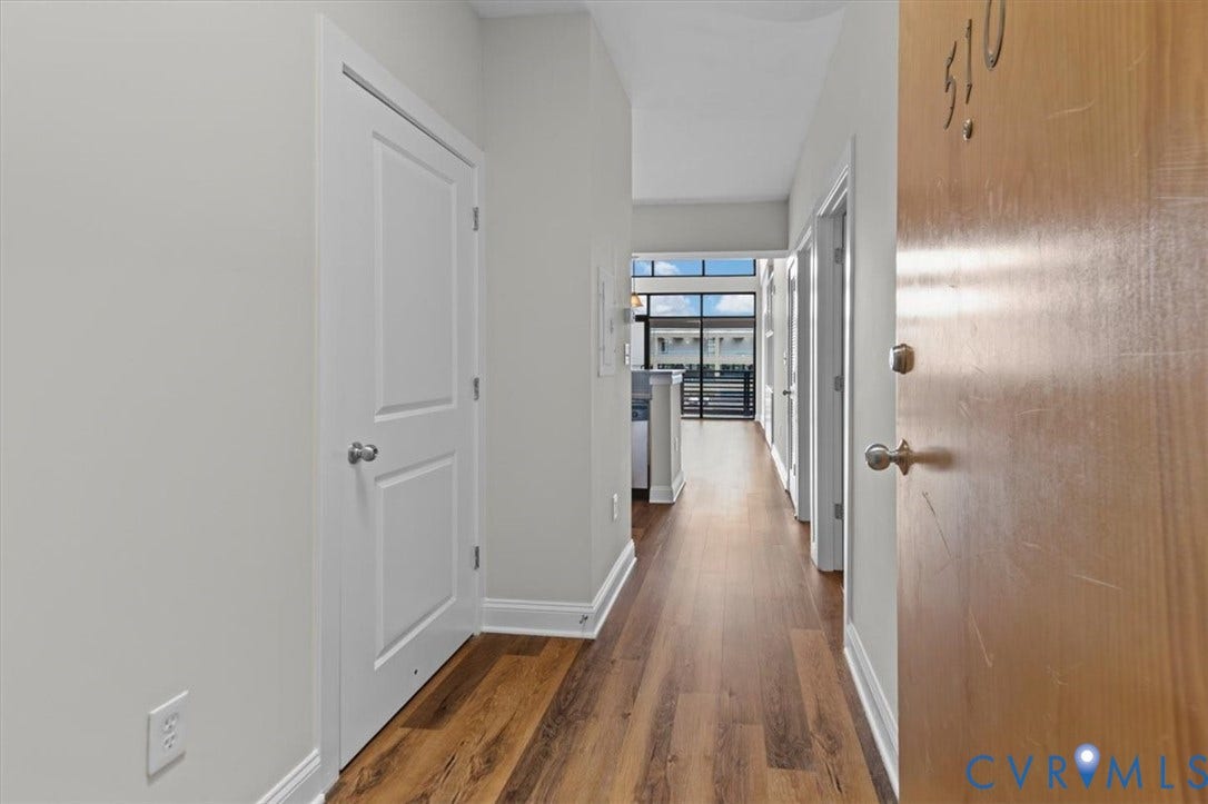 1333 Broad Street, #510, Ironhouse Place Condominiums, Richmond, VA 23220 Long hallway featuring wood-finish flooring, light grey walls, and white trim