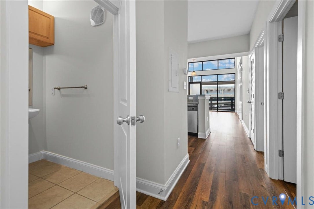 1333 Broad Street, #510, Ironhouse Place Condominiums, Richmond, VA 23220 Hallway featuring wood-finish flooring, white baseboards, and light grey walls