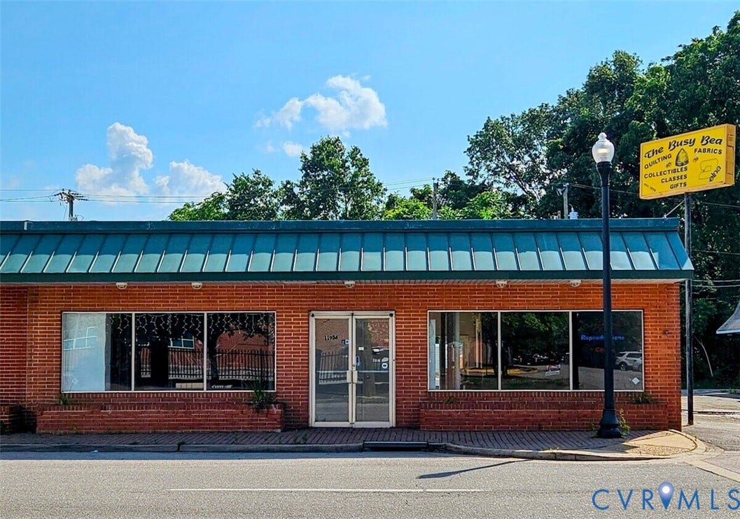 11934 Centre Street, Chester, VA 23831 Brick facade with large storefront windows and a green metal awning