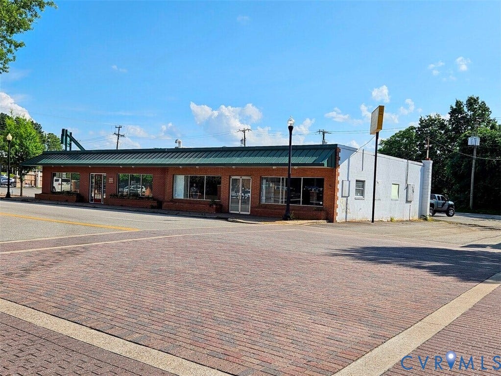 11934 Centre Street, Chester, VA 23831 Commercial building featuring a brick facade with large storefront windows and a green metal awning