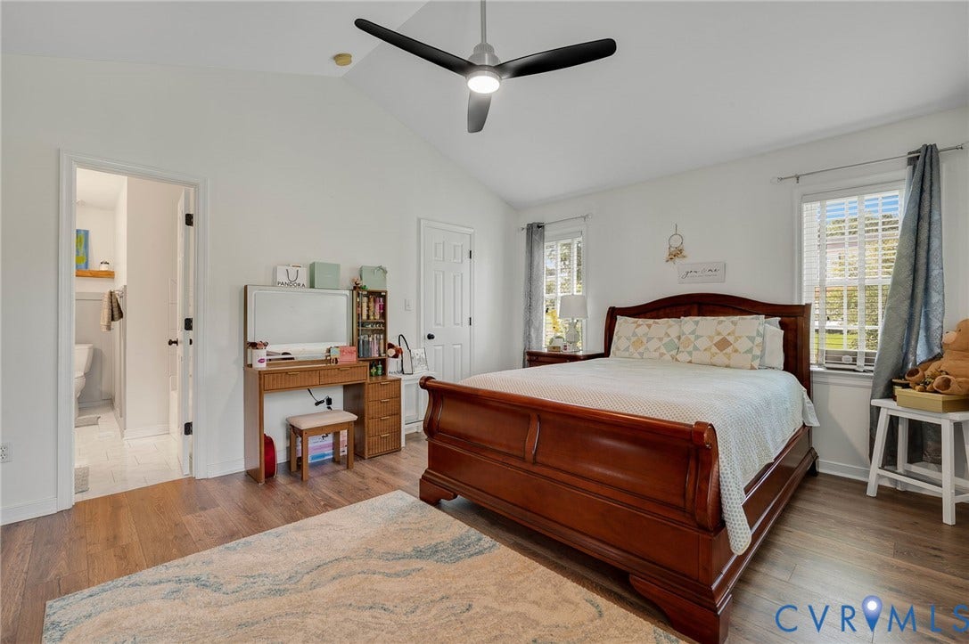 5612 Jessup Station Place, Chesterfield, VA 23234 Vaulted ceiling bedroom featuring wood-finish flooring, a modern ceiling fan, and two windows with natural light