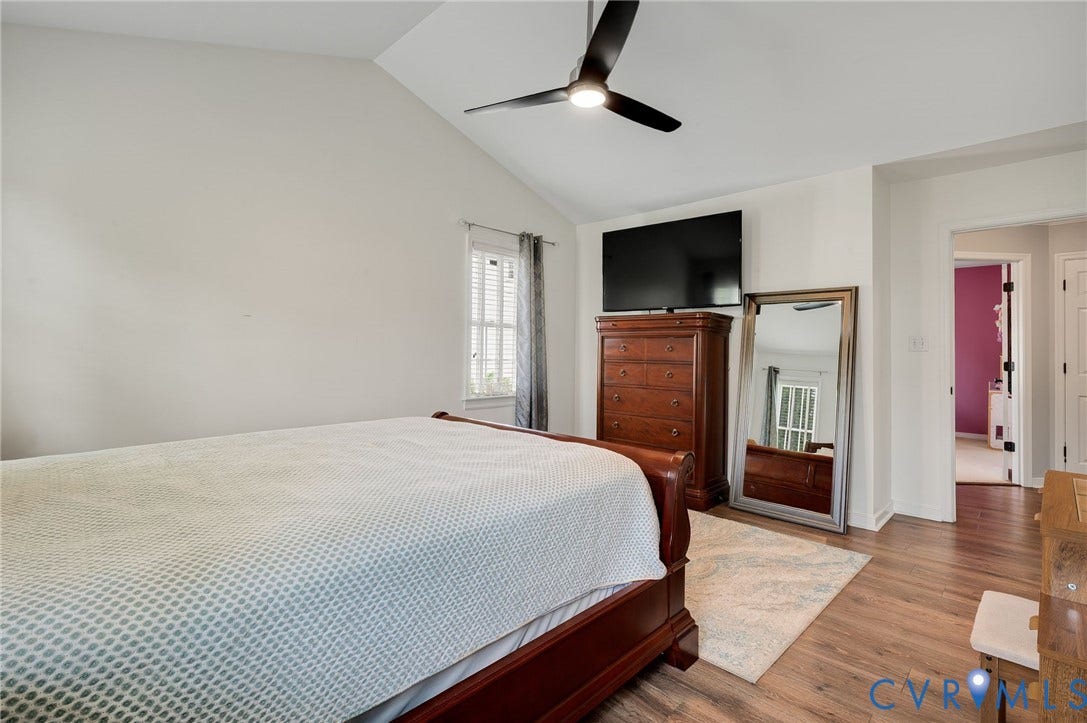 5612 Jessup Station Place, Chesterfield, VA 23234 Vaulted ceiling bedroom featuring wood-finish flooring, a ceiling fan with integrated lighting, and a window with blinds