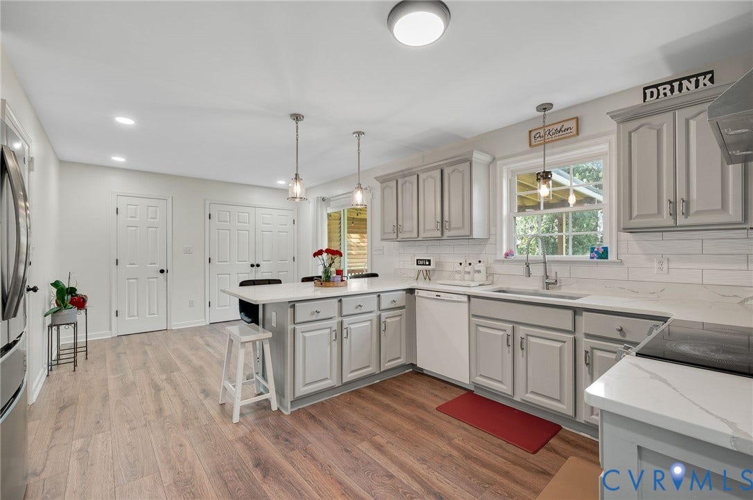 5612 Jessup Station Place, Chesterfield, VA 23234 Kitchen featuring light gray cabinetry, white countertops, wood-finish flooring, a central island, and a window with a garden view