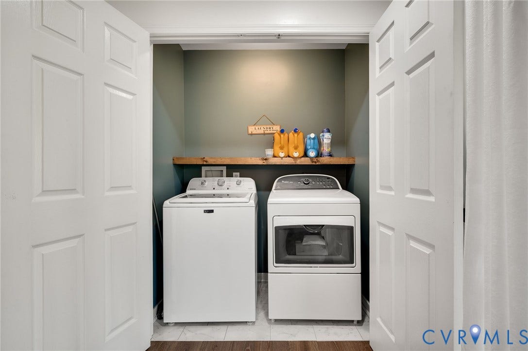 5612 Jessup Station Place, Chesterfield, VA 23234 Laundry alcove featuring a washer and dryer, wood-finish shelving, and a tiled floor