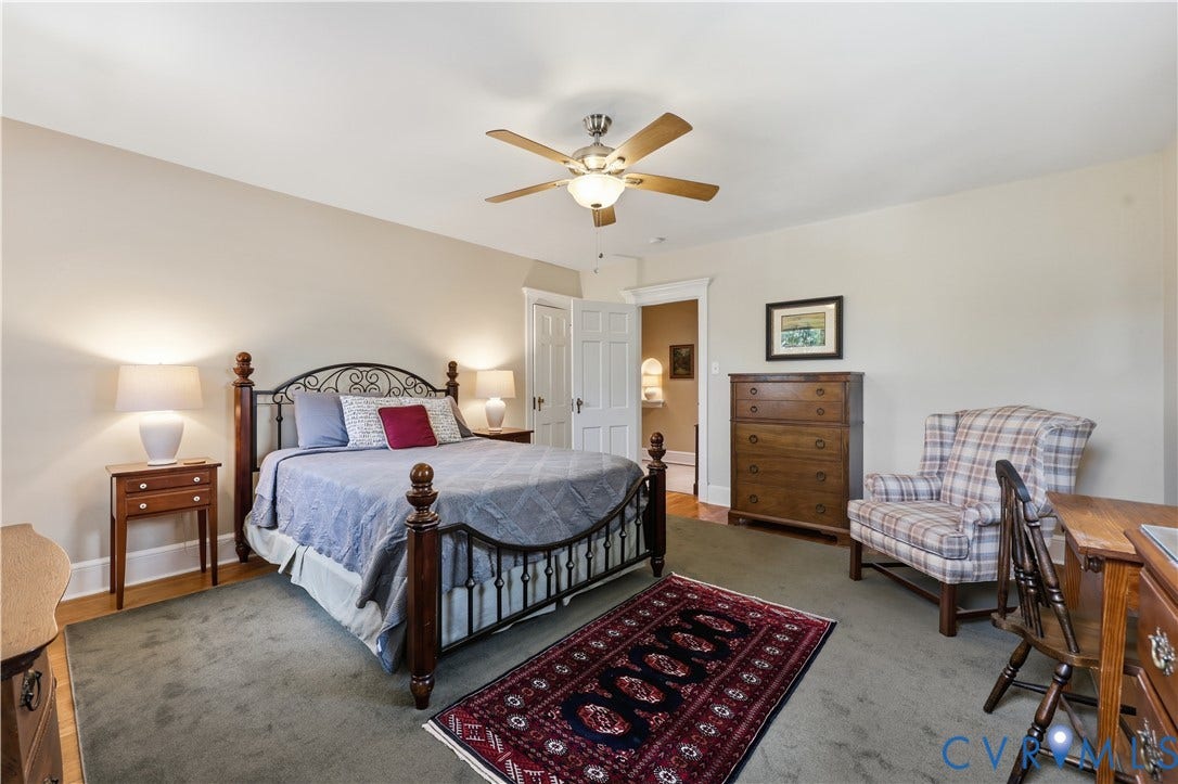 4207 W Grace Street, Sauer's Gardens, Richmond, VA 23230 Carpeted bedroom featuring a ceiling fan with integrated lighting, a doorway with white trim, and light-toned walls