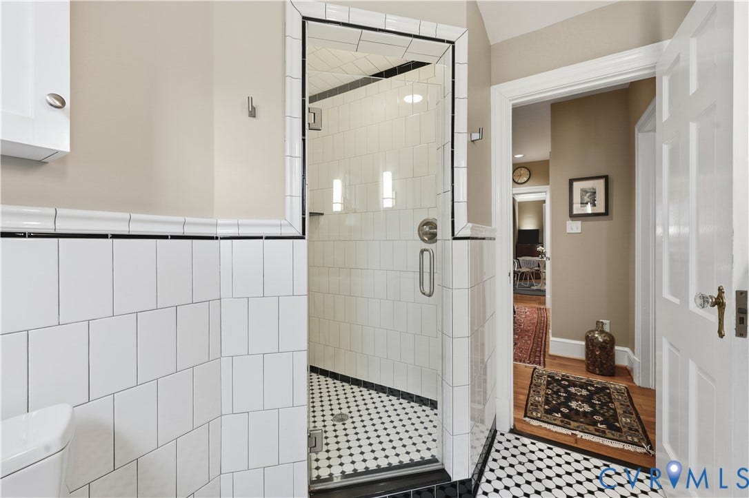 4207 W Grace Street, Sauer's Gardens, Richmond, VA 23230 Glass-enclosed shower with white subway tile walls and black-and-white hex floor tile