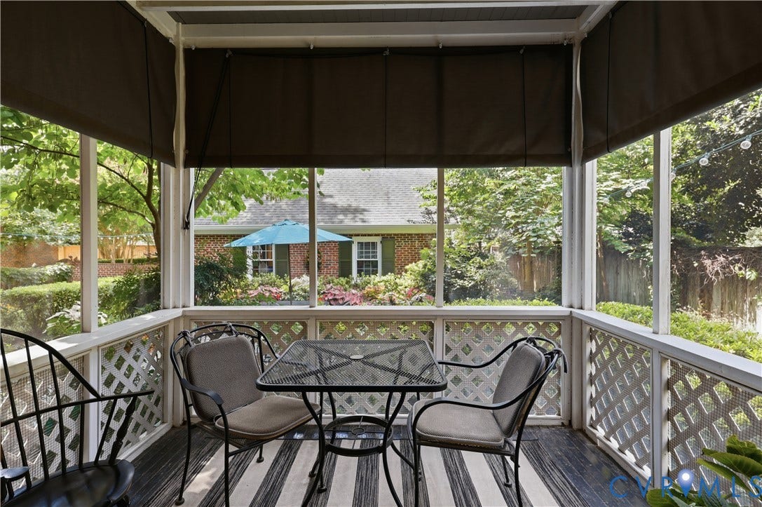 4207 W Grace Street, Sauer's Gardens, Richmond, VA 23230 Screened porch featuring white lattice railing, dark roll-down shades, and a striped outdoor rug