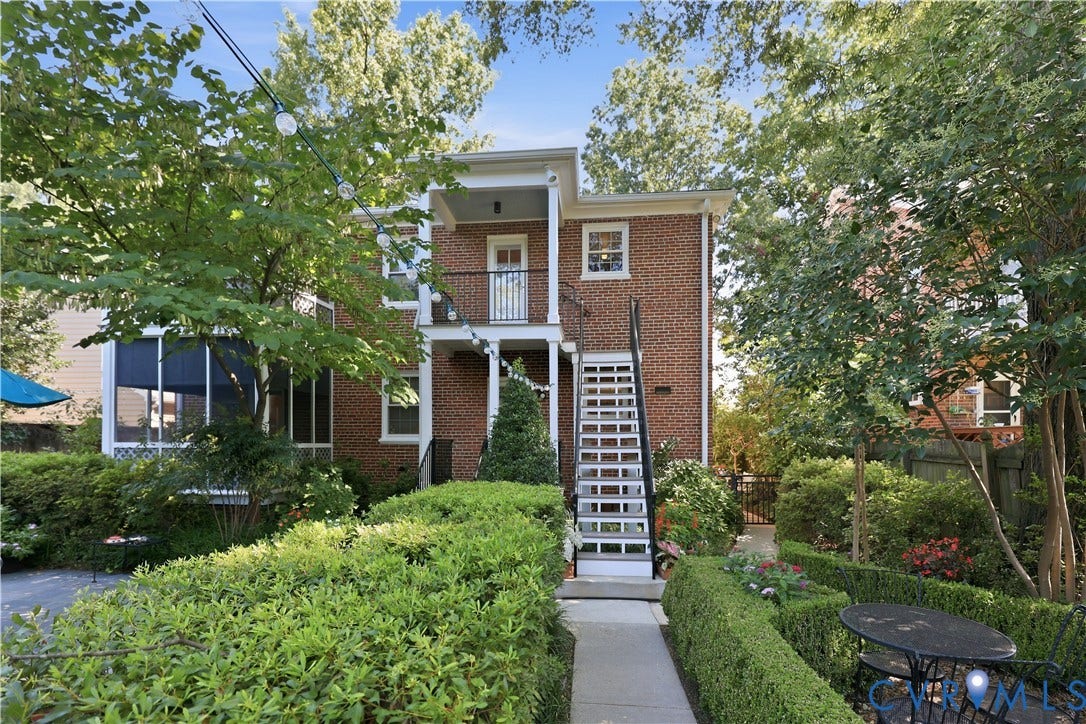 4207 W Grace Street, Sauer's Gardens, Richmond, VA 23230 Brick exterior featuring a screened porch, a second-story balcony with metal railing, and an exterior staircase