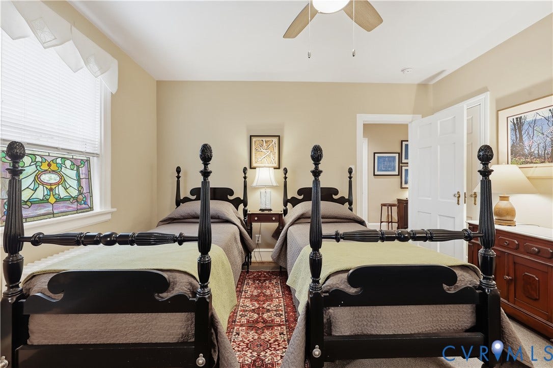 4207 W Grace Street, Sauer's Gardens, Richmond, VA 23230 Interior room featuring a stained-glass window, neutral wall tones, a ceiling fan, a paneled interior door, and wood-finish flooring