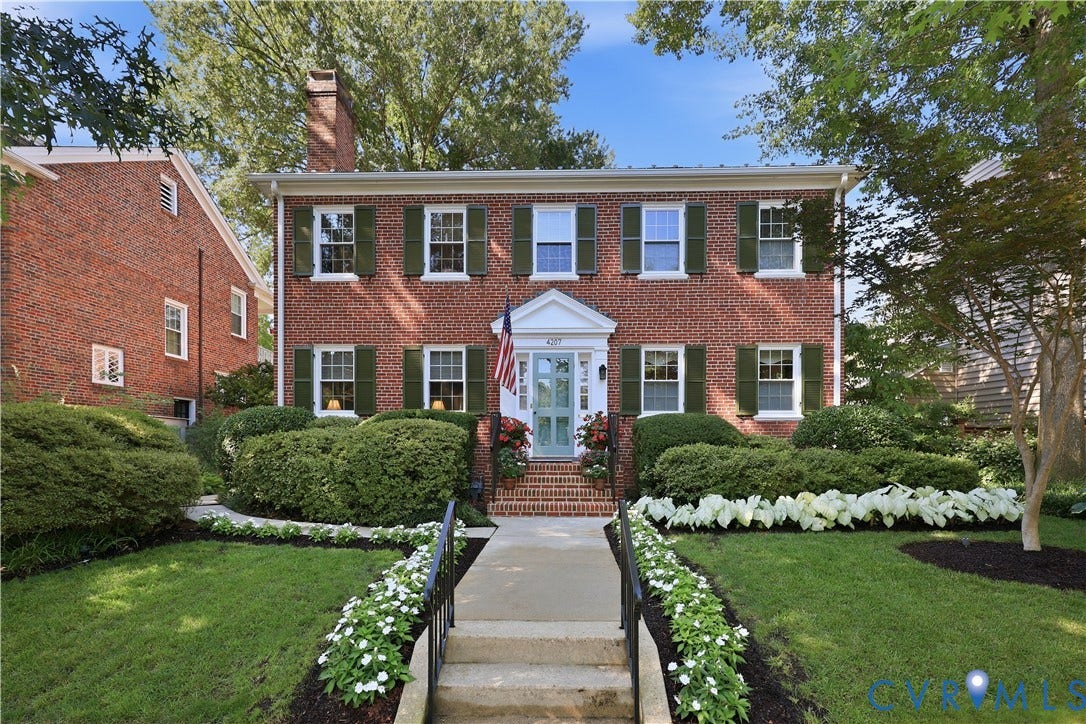 4207 W Grace Street, Sauer's Gardens, Richmond, VA 23230 Brick Colonial-style residence featuring green shutters and a light blue front door with a transom window