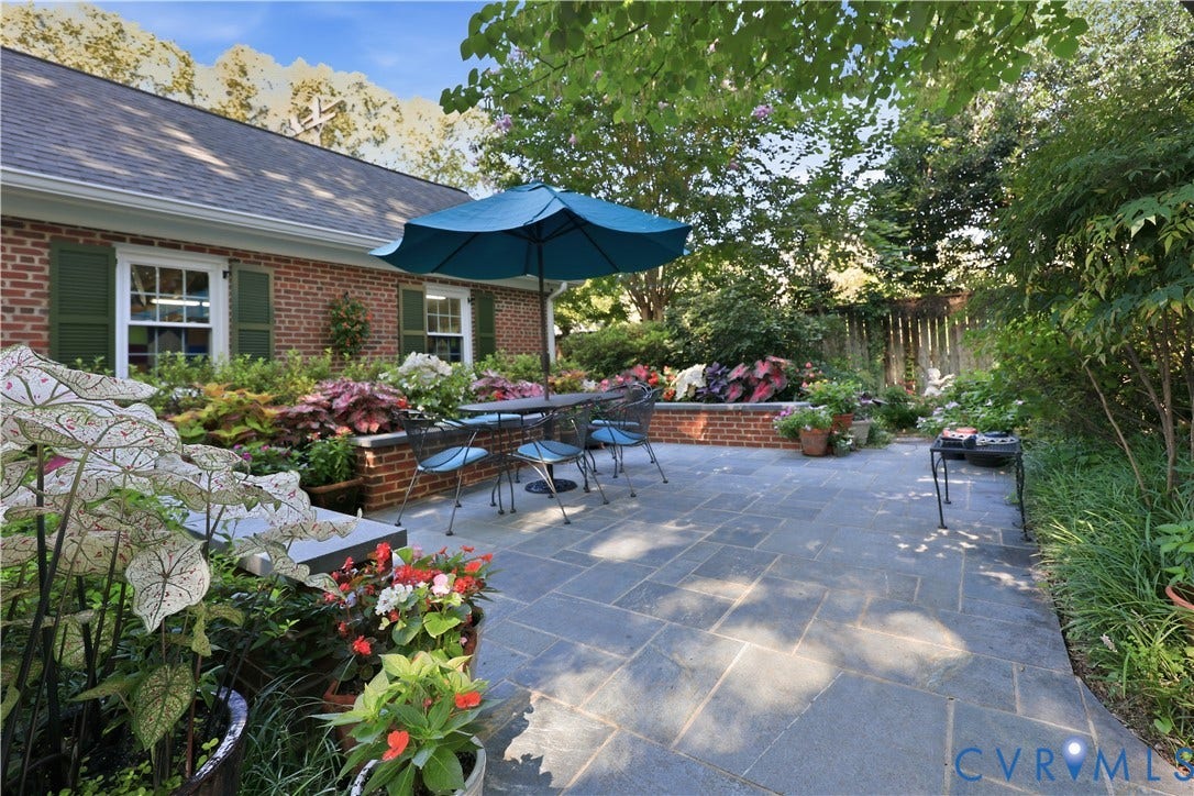 4207 W Grace Street, Sauer's Gardens, Richmond, VA 23230 Expansive paver patio with a brick retaining wall and established garden beds