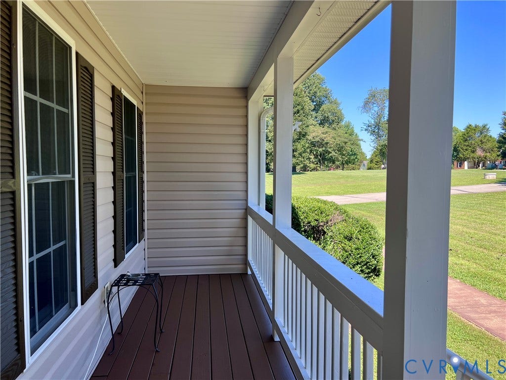 2301 Graceland Drive, Powhatan, VA 23139 Inviting front porch with a rich brown deck, white railing, and columns