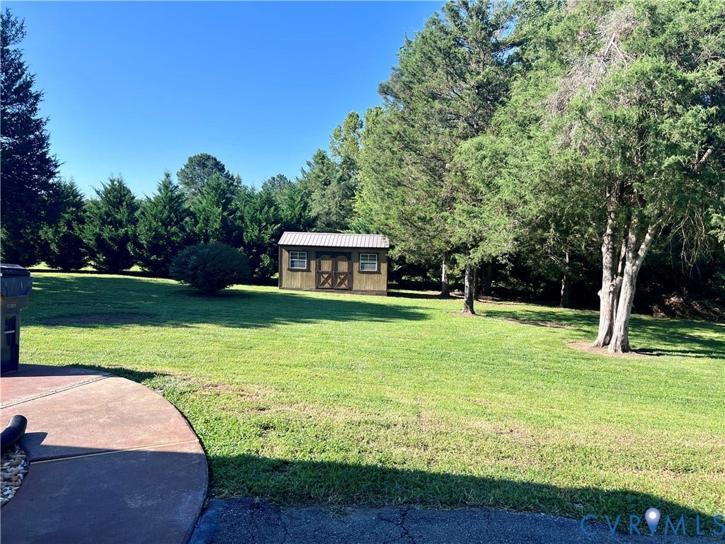 2301 Graceland Drive, Powhatan, VA 23139 Expansive green lawn with mature trees and a dedicated storage shed