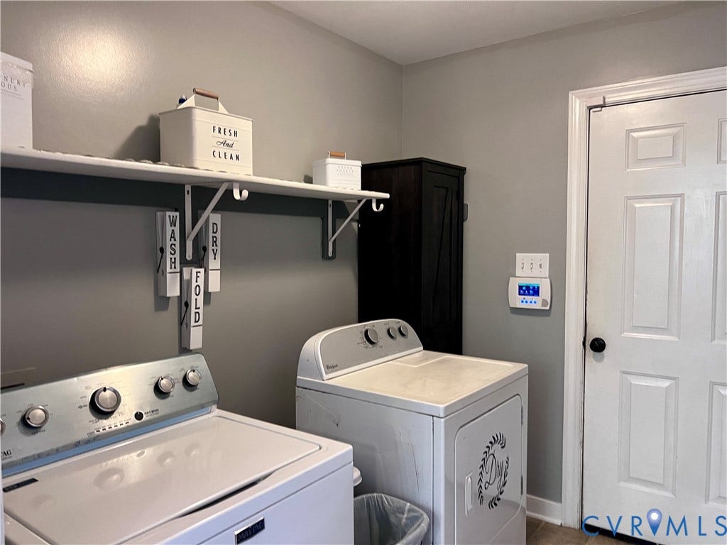2301 Graceland Drive, Powhatan, VA 23139 Dedicated laundry area featuring a wall-mounted shelf, neutral wall color, and a dark wood-finish storage cabinet
