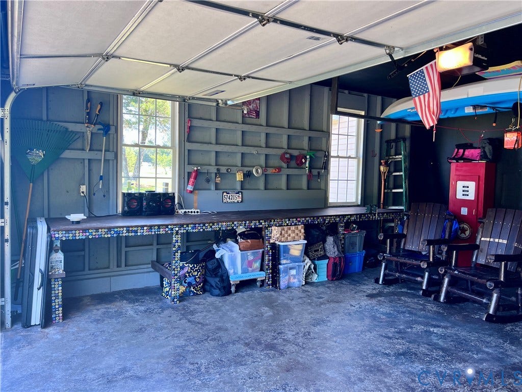2301 Graceland Drive, Powhatan, VA 23139 Garage space featuring a built-in workbench with a mosaic-tile facade and a wood-finish top