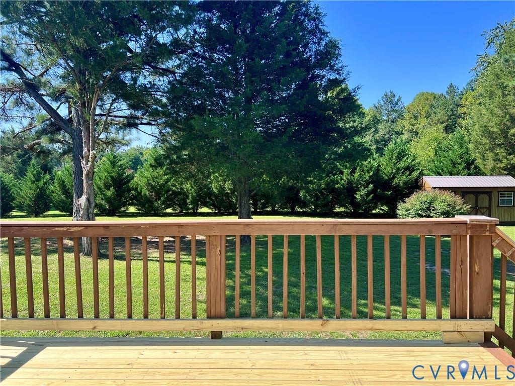 2301 Graceland Drive, Powhatan, VA 23139 Spacious wood deck with a natural wood railing overlooking a grassy yard with mature trees