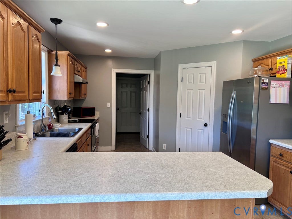 2301 Graceland Drive, Powhatan, VA 23139 Kitchen with light wood cabinetry, light-toned countertops, stainless steel appliances, recessed ceiling lights, and a pendant light fixture