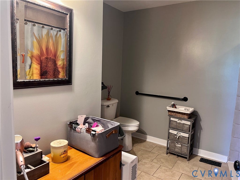 2301 Graceland Drive, Powhatan, VA 23139 Bathroom featuring light gray walls, a white toilet, and beige tile flooring
