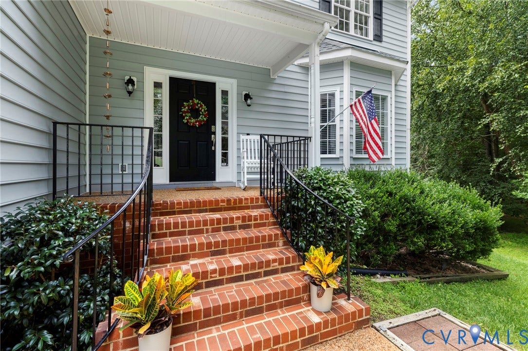 8343 Shagreen Court, The Highlands, Chesterfield, VA 23838 Brick stairs with black wrought iron railings leading to a covered porch with a dark-paneled door