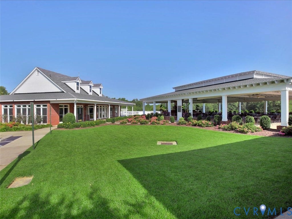 8343 Shagreen Court, The Highlands, Chesterfield, VA 23838 Brick building with white trim, multiple dormer windows, and a covered porch