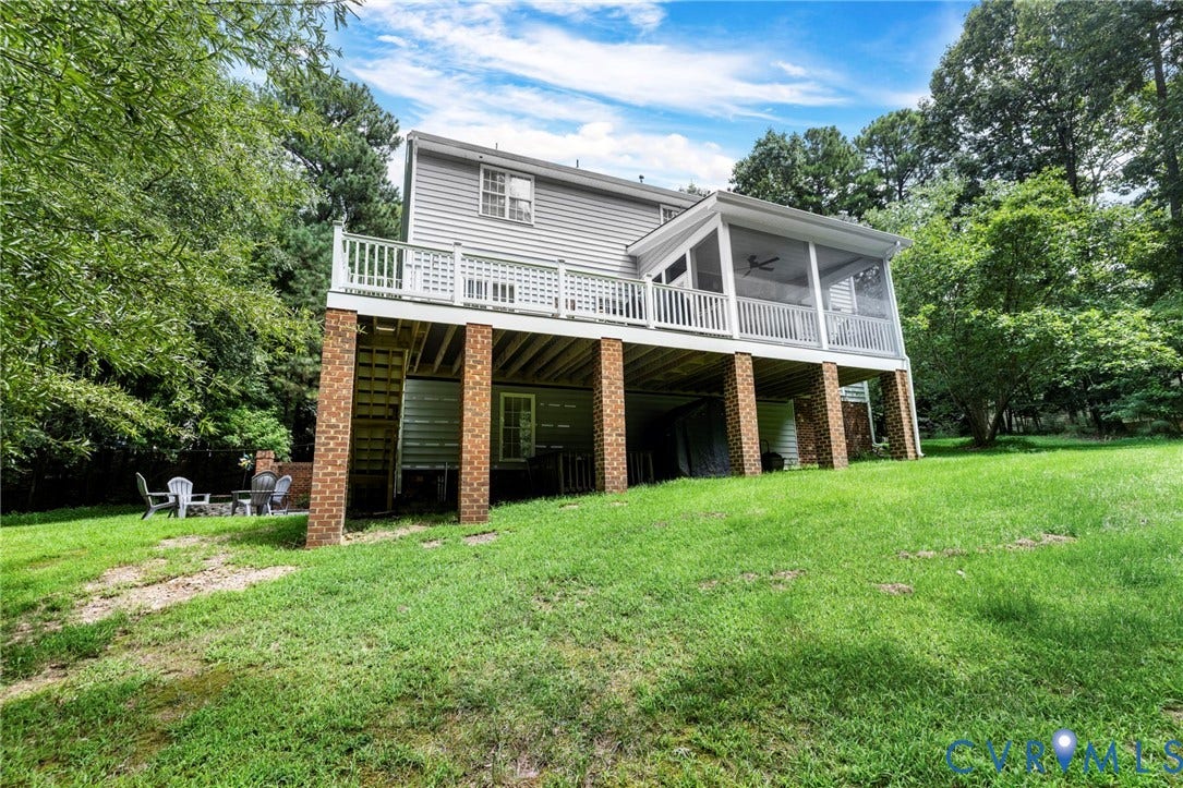 8343 Shagreen Court, The Highlands, Chesterfield, VA 23838 Expansive green lawn with mature perimeter trees, featuring a screened porch with ceiling fan, an open deck, and a brick-supported foundation