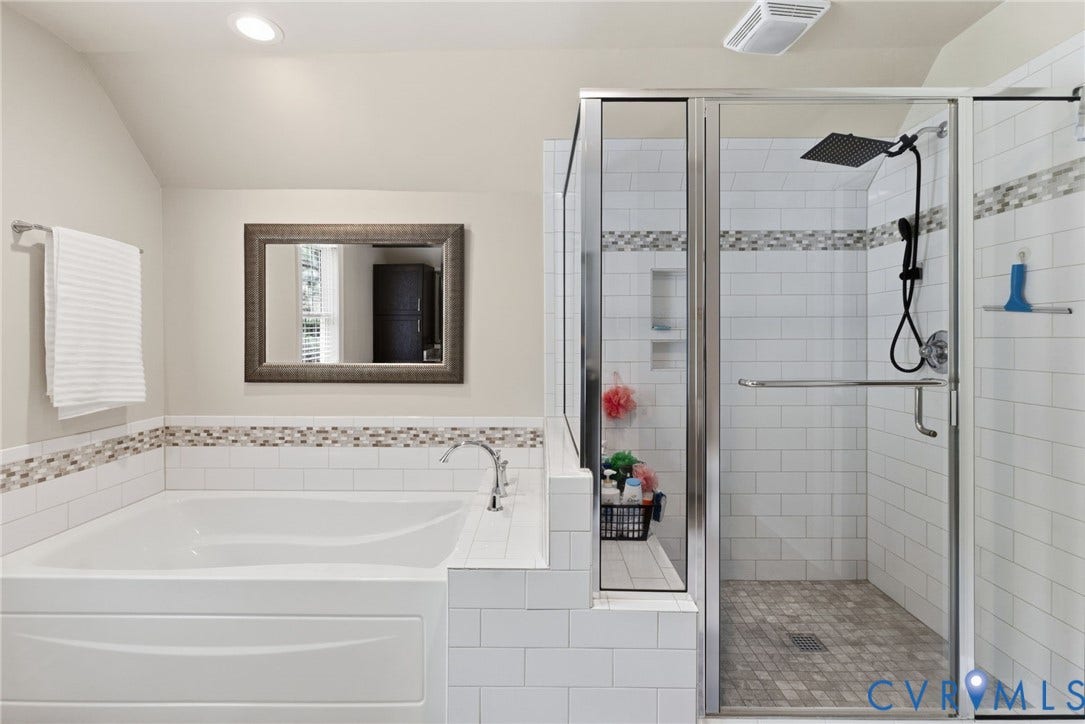 8343 Shagreen Court, The Highlands, Chesterfield, VA 23838 White soaking tub, glass-enclosed shower with subway tile surround, mosaic accent tile, and matte black shower fixtures