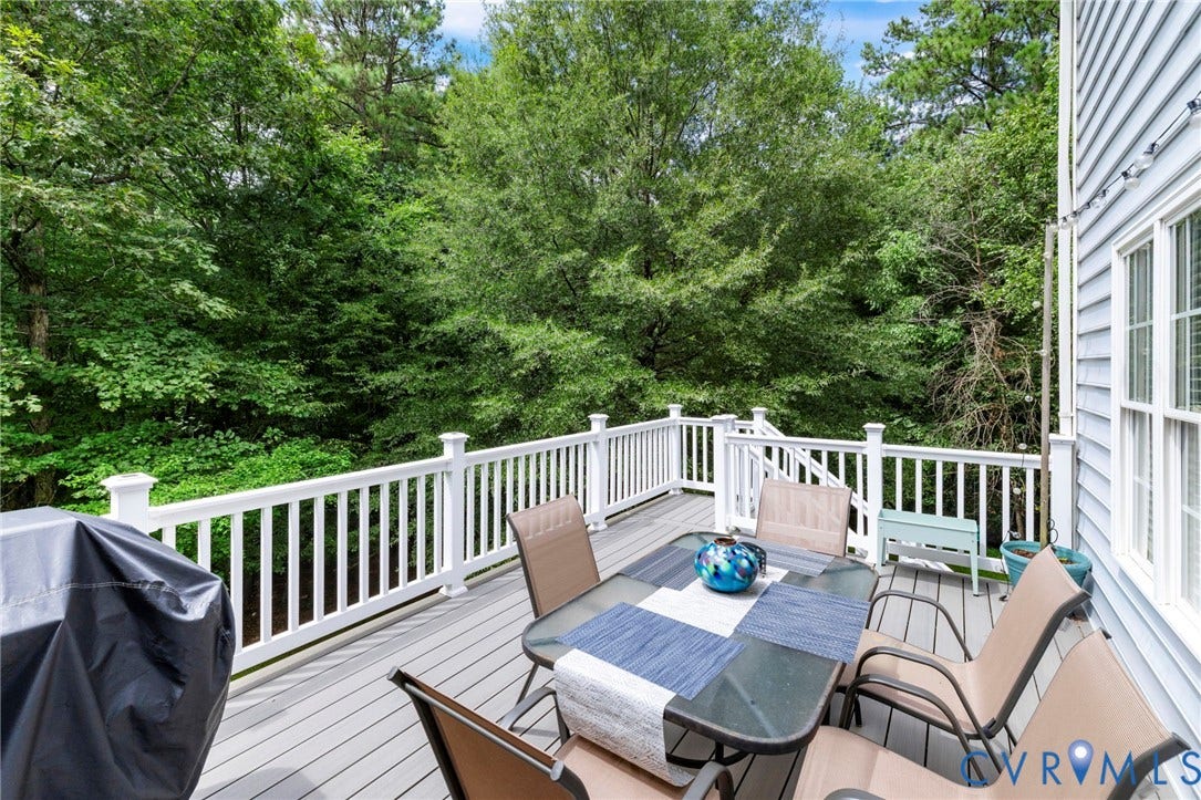 8343 Shagreen Court, The Highlands, Chesterfield, VA 23838 Spacious elevated deck with white railings and gray composite decking, featuring a multi-pane window and light blue siding