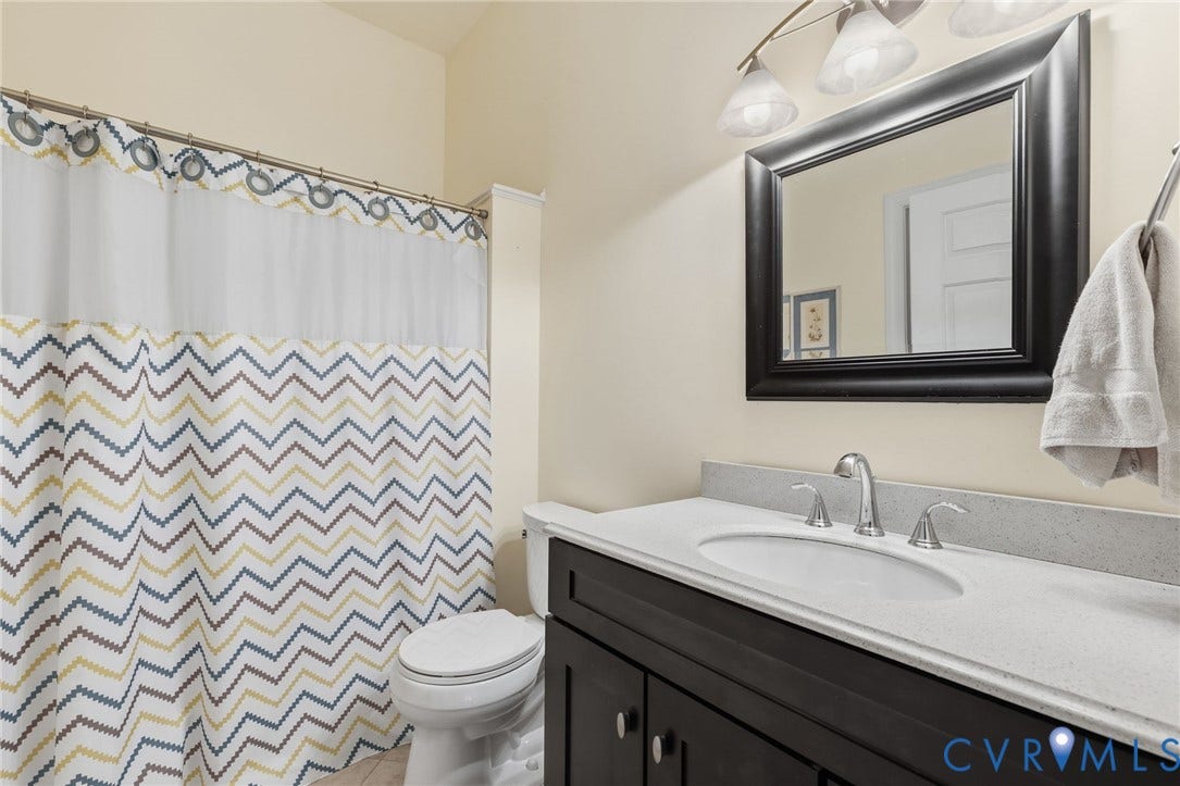 8343 Shagreen Court, The Highlands, Chesterfield, VA 23838 Built-in vanity with a stone-finish countertop, undermount sink, and chrome fixtures