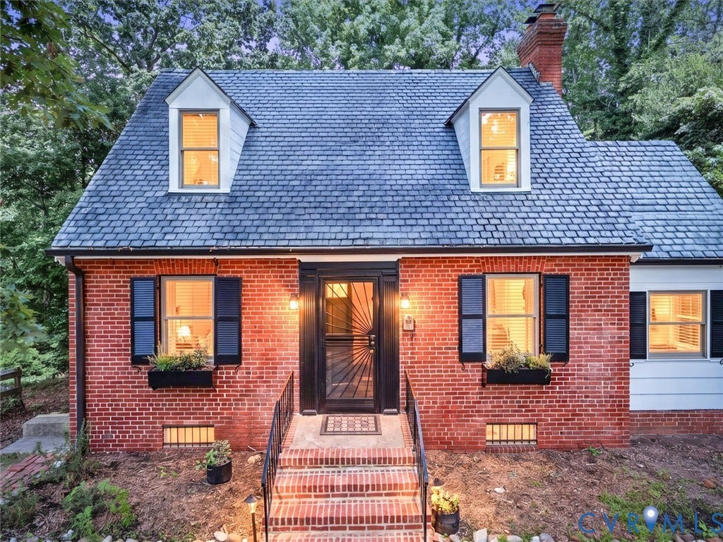Red brick exterior with a gray shingle roof