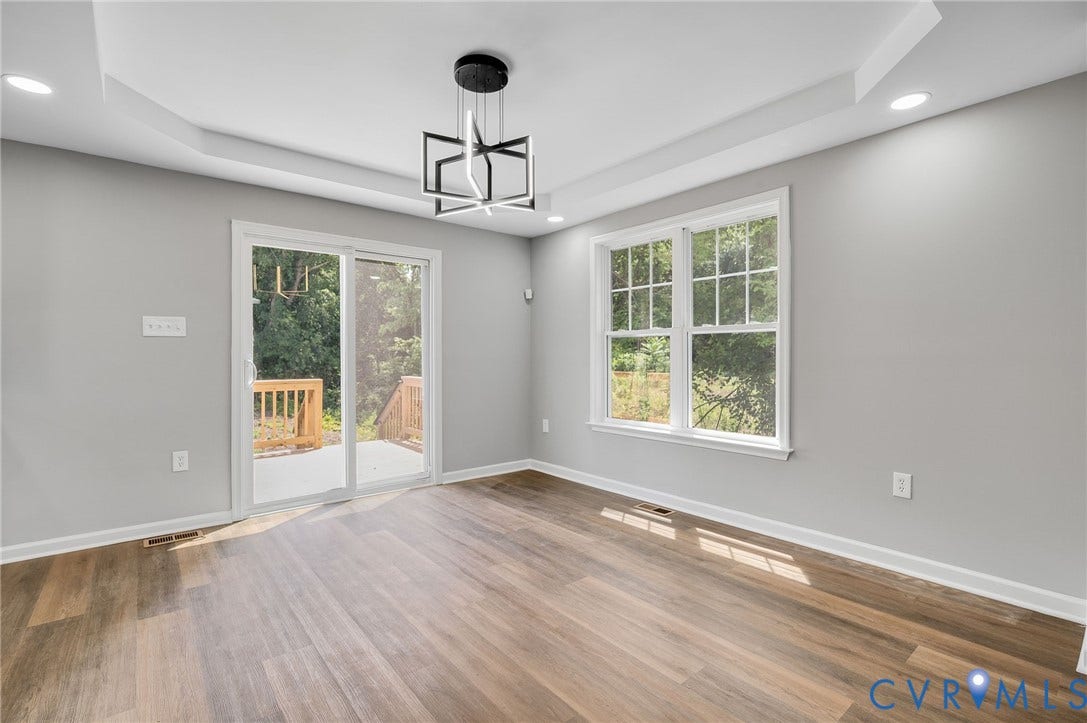 425 BYRNE Street, Petersburg, VA 23803 Spacious room featuring wood-finish flooring, light grey walls, and a contemporary ceiling fixture