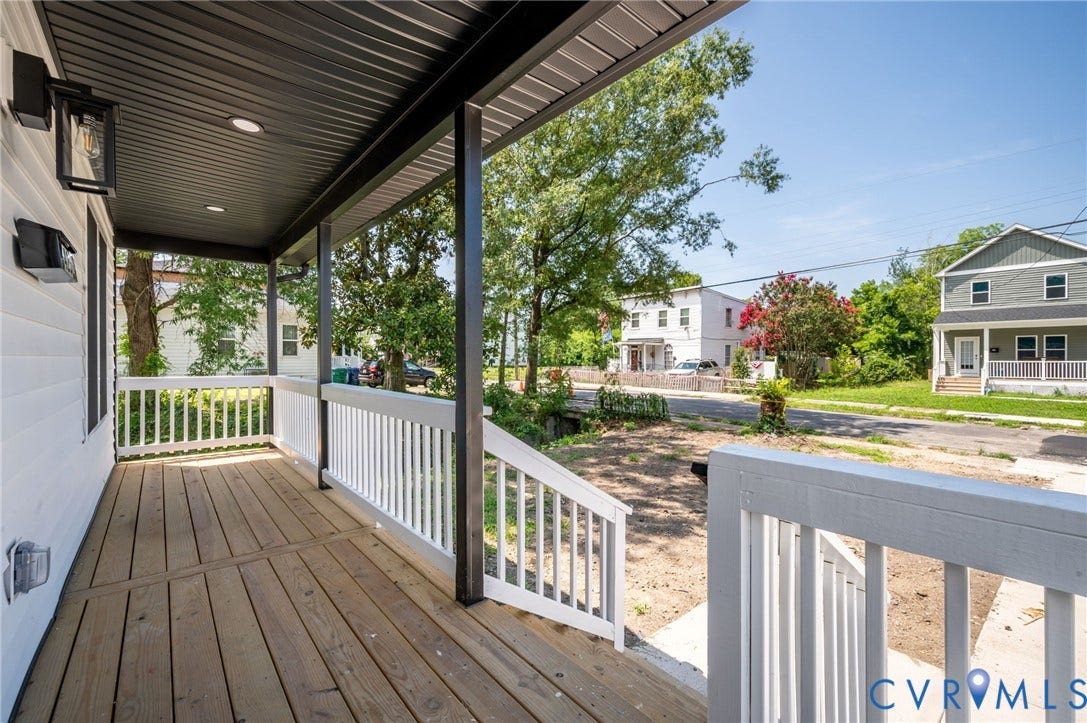 425 BYRNE Street, Petersburg, VA 23803 Front porch featuring wood-finish decking, white railing, and a dark corrugated ceiling with recessed lighting
