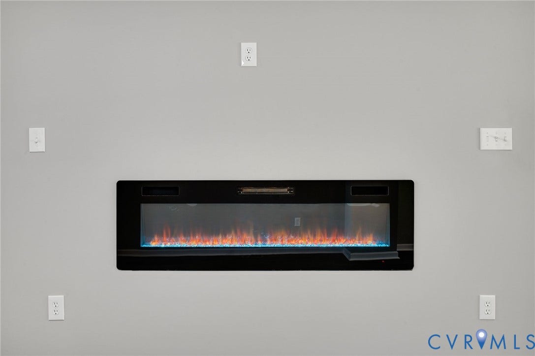 425 BYRNE Street, Petersburg, VA 23803 Wall-mounted electric fireplace with a black glass front