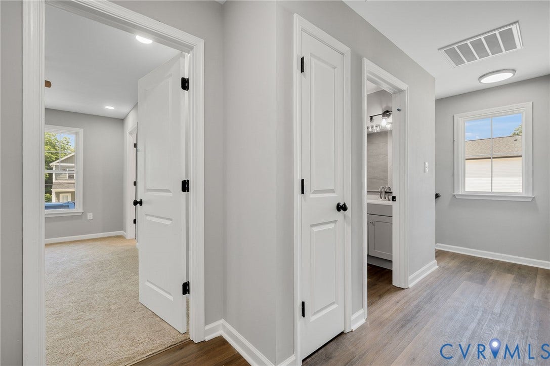 425 BYRNE Street, Petersburg, VA 23803 Hallway featuring wood-finish flooring, light gray walls, and white trim