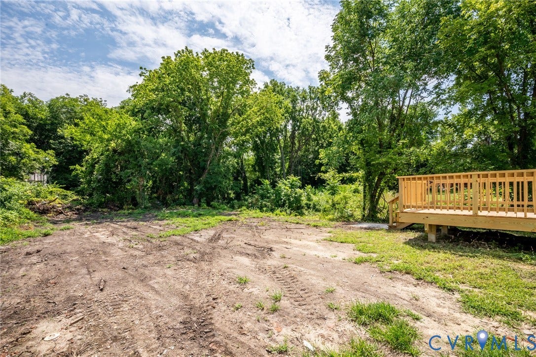 425 BYRNE Street, Petersburg, VA 23803 Expansive lot featuring a newly constructed wood deck with railings, surrounded by mature trees