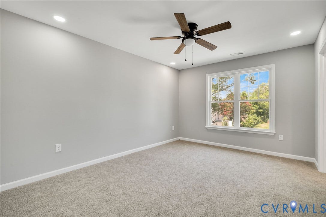 425 BYRNE Street, Petersburg, VA 23803 Carpeted room featuring a white-framed window, recessed ceiling lights, a ceiling fan with wood-finish blades, and neutral-toned wall paint