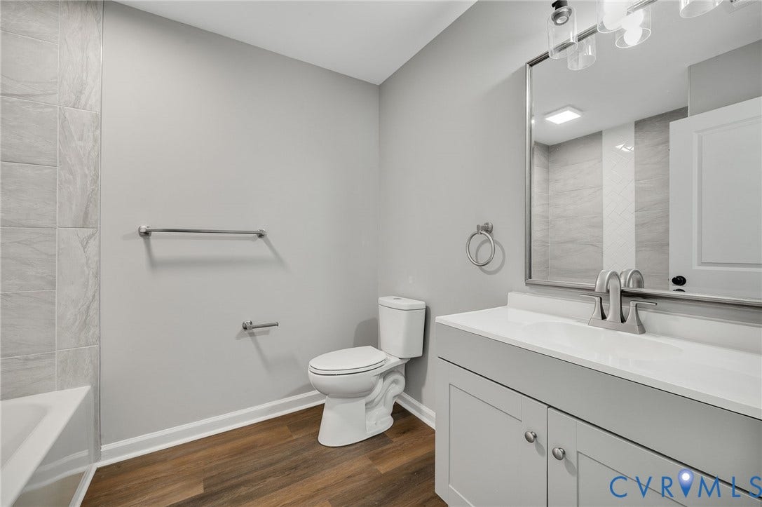 425 BYRNE Street, Petersburg, VA 23803 Bathroom featuring a single vanity with a white countertop, light gray cabinetry, and a chrome faucet