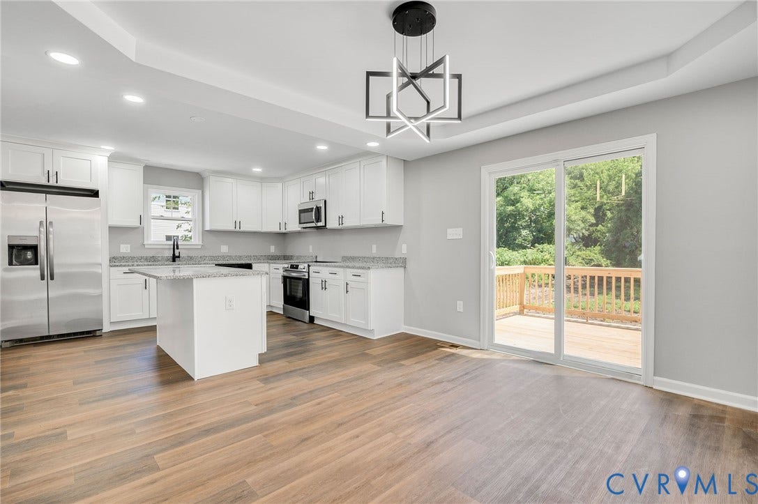 425 BYRNE Street, Petersburg, VA 23803 Kitchen featuring white cabinetry, granite countertops, stainless steel appliances, a central island, and wood-finish flooring