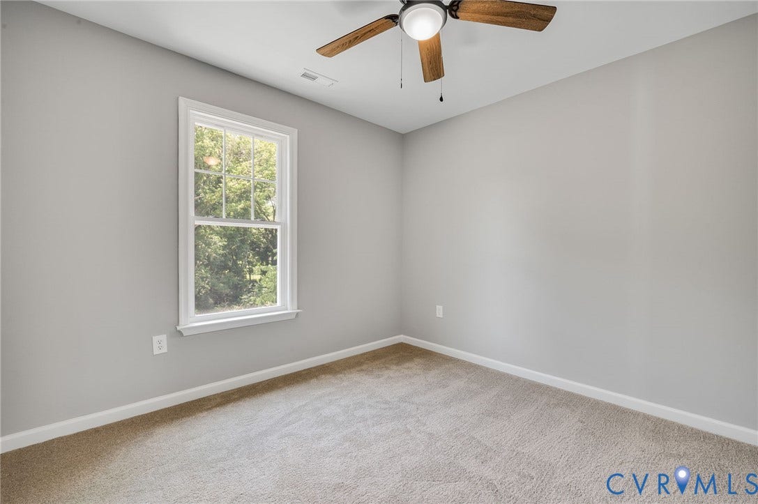 425 BYRNE Street, Petersburg, VA 23803 Carpeted room featuring a single window with white trim, a ceiling fan with wood-finish blades, light gray wall paint, and white baseboards