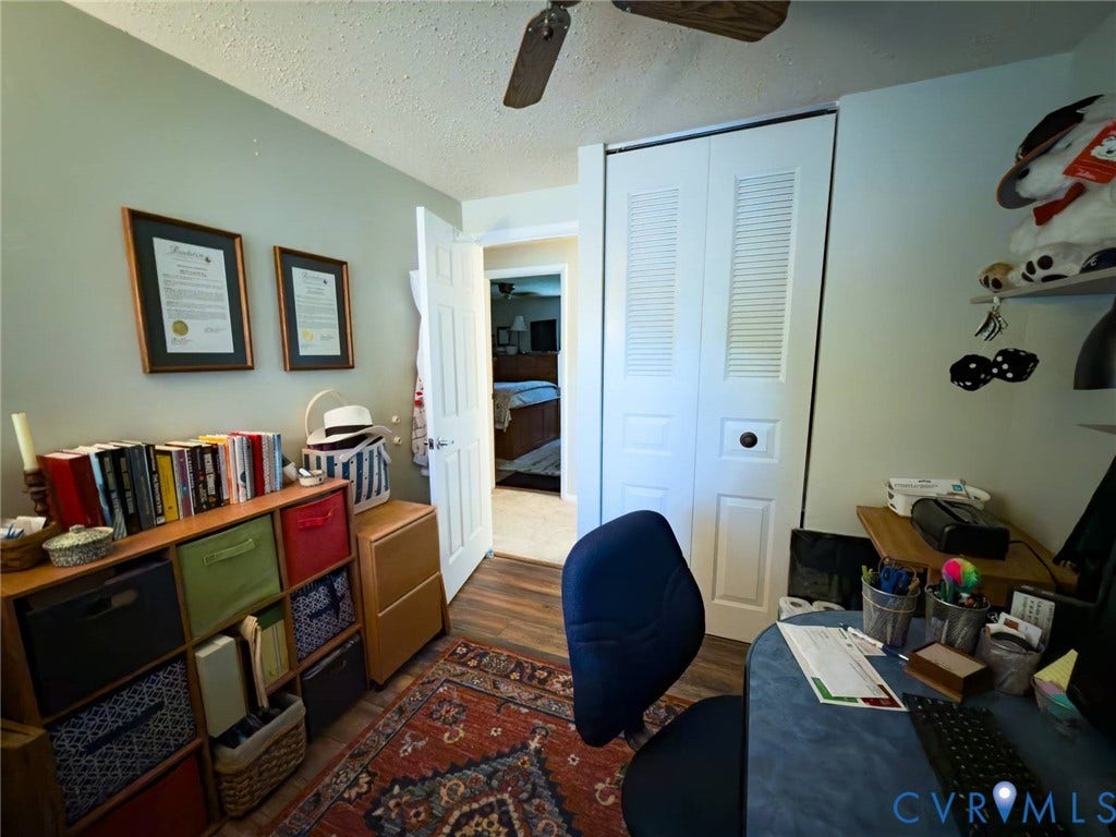 4900 Cord Court, Bridgewood, Glen Allen, VA 23060 Versatile home office featuring hardwood flooring, built-in storage cabinetry with multi-colored finishes, and ample natural lighting from multiple windows