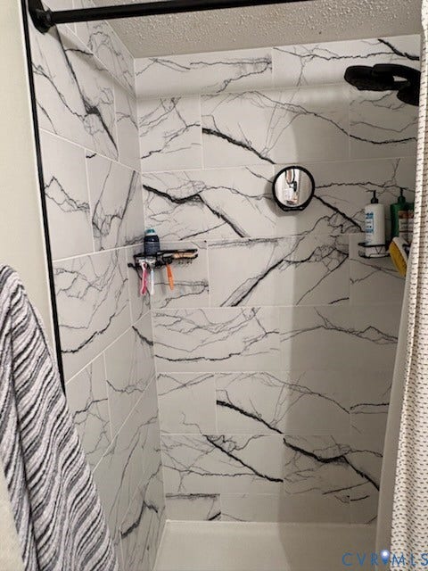 4900 Cord Court, Bridgewood, Glen Allen, VA 23060 Shower enclosure with white and black patterned tile walls