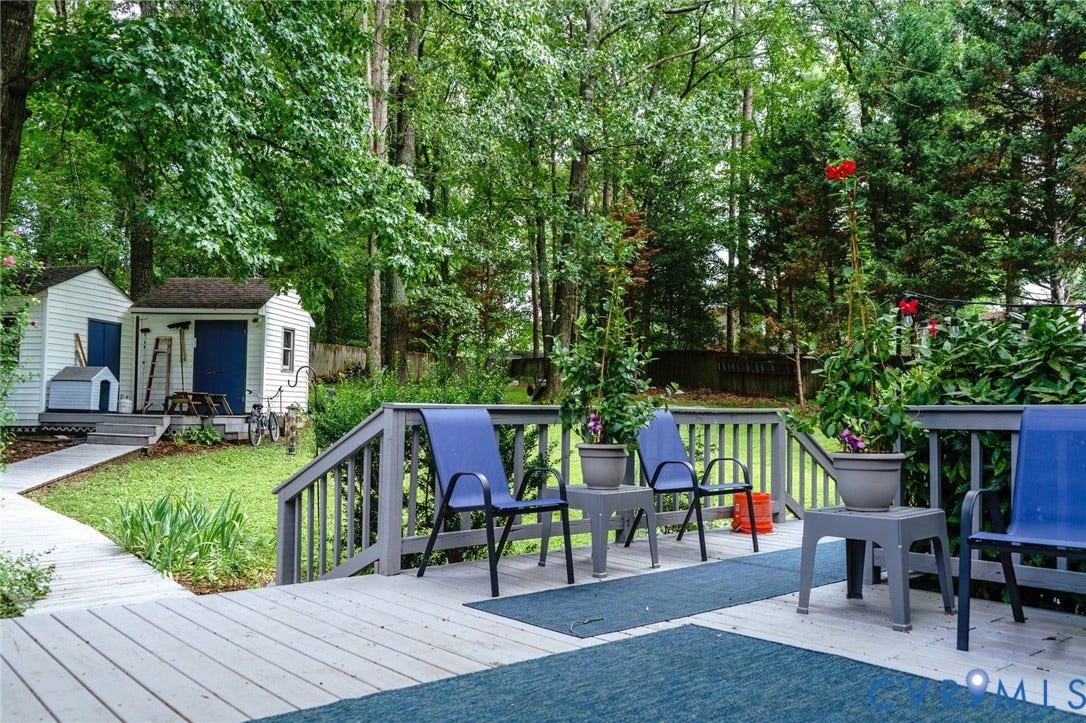 4900 Cord Court, Bridgewood, Glen Allen, VA 23060 Out door living space featuring comfortable seating areas, composite decking, and mature landscaping with tall trees providing natural screening