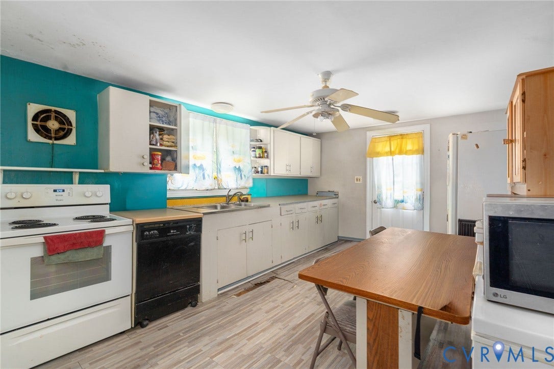 5927 Swanson Road, Richmond, VA 23225 Kitchen featuring wood-finish flooring and white cabinetry