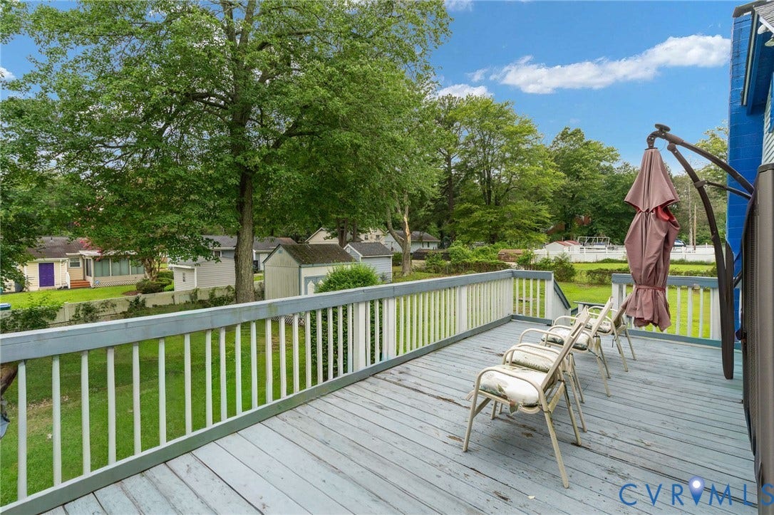 5927 Swanson Road, Richmond, VA 23225 Expansive wooden deck with white railing overlooking a green lawn