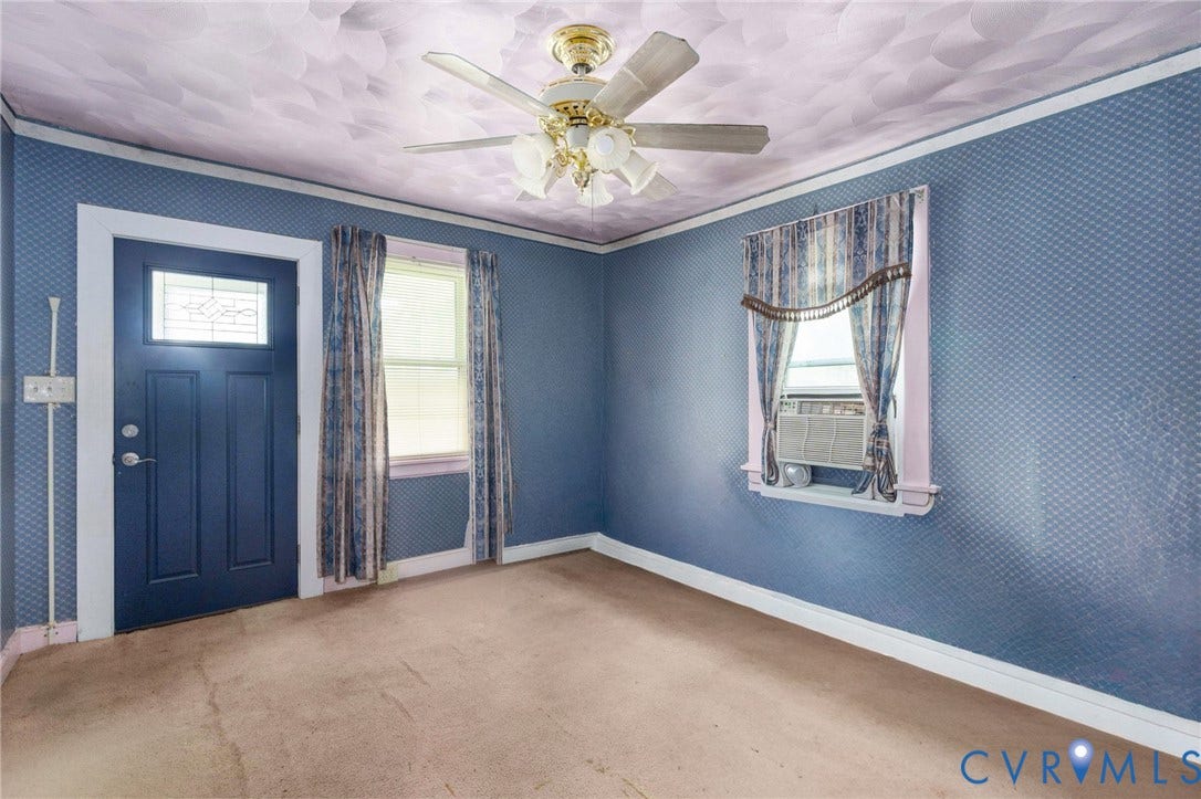 5927 Swanson Road, Richmond, VA 23225 Room featuring a ceiling fan with integrated lighting, two windows, and a panel door with a decorative glass insert