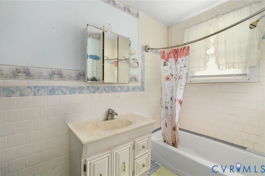 5927 Swanson Road, Richmond, VA 23225 Bathroom featuring a white bathtub, vanity with integrated sink, and white tiled walls