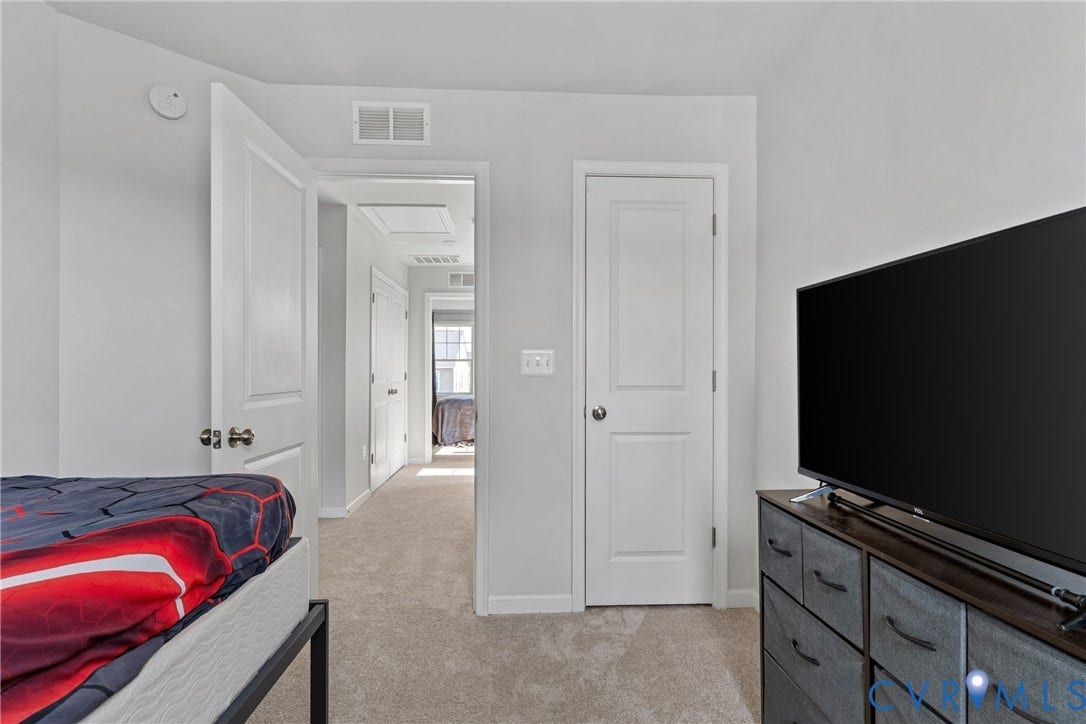 Light gray wall paint, white trim, and light-toned carpeting throughout