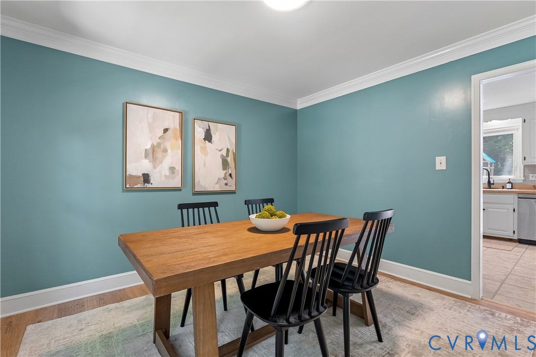 Dining room showcasing turquoise walls with crisp white crown molding and ceiling detail