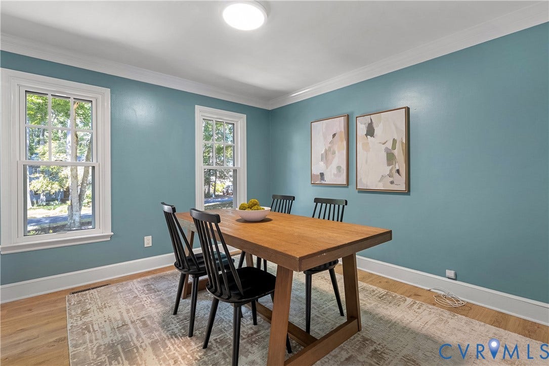 Dining room featuring turquoise walls, recessed ceiling lighting, and hardwood flooring