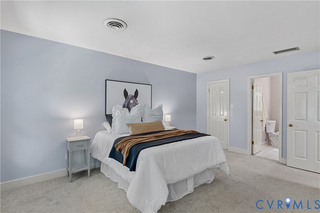 Light gray carpeting, light blue wall paint, white trim, and white paneled doors