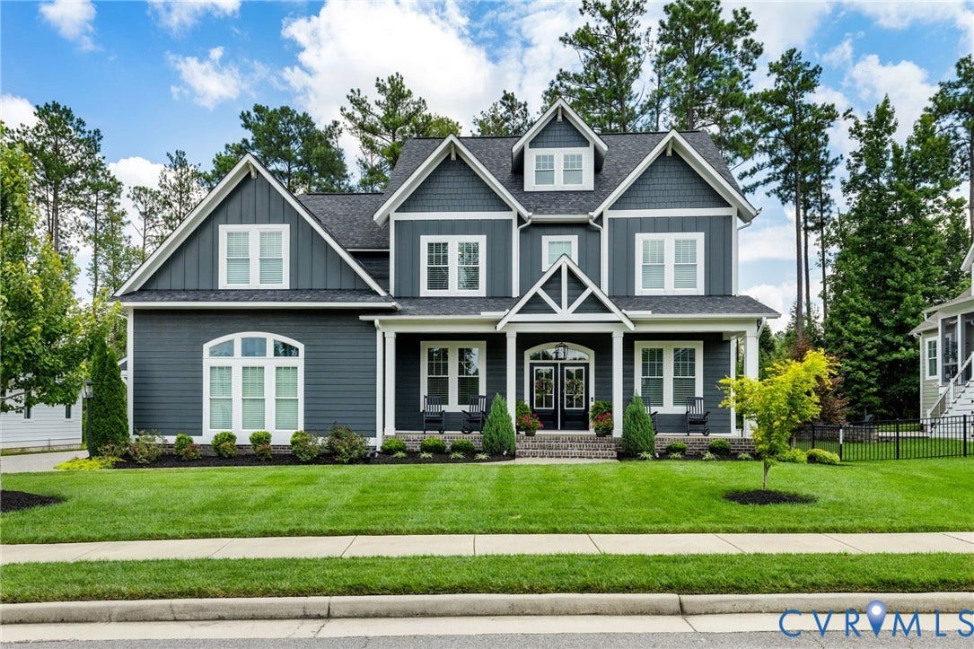7237 Bonallack Bend, Carlton Ridge, Moseley, VA 23120 Striking Colonial-style residence featuring a symmetrical faade with multiple gabled rooflines, gray fiber cement siding, and white trim accents